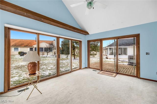 unfurnished sunroom with lofted ceiling, ceiling fan, and visible vents