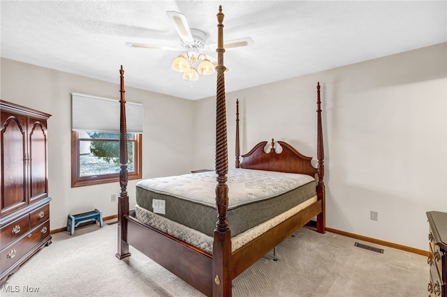 bedroom featuring visible vents, light carpet, and baseboards