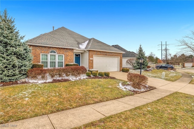 view of front of property featuring a garage, brick siding, driveway, roof with shingles, and a front lawn