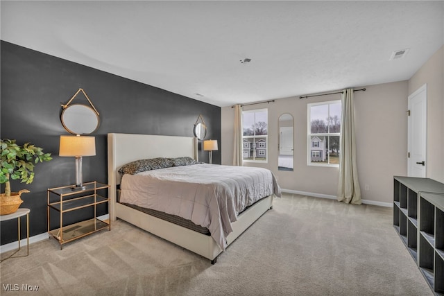 bedroom featuring carpet flooring, visible vents, and baseboards