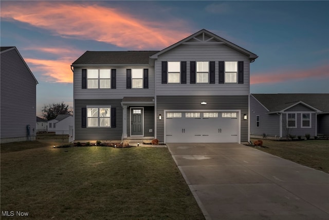 view of front of home with driveway, an attached garage, and a front yard