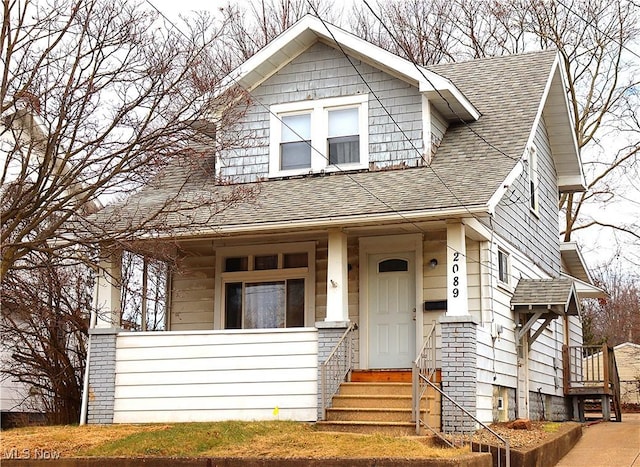 view of front of property with a shingled roof and covered porch