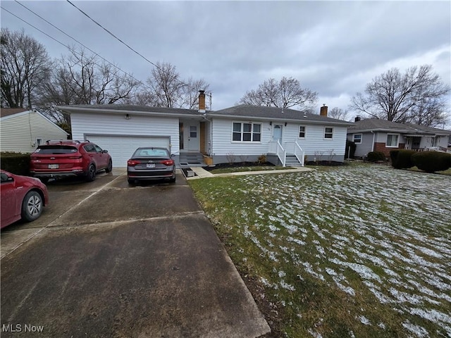 single story home with driveway, a chimney, and an attached garage