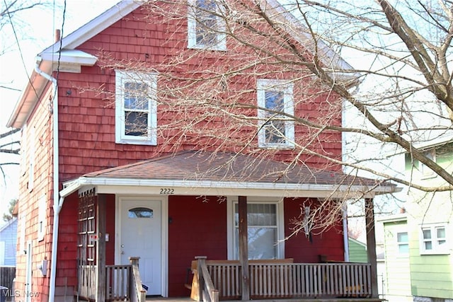 view of front of property featuring a porch and a shingled roof