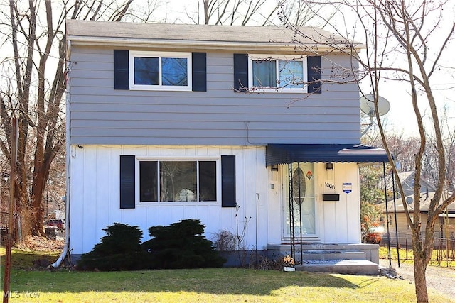 view of front of home featuring board and batten siding and a front yard