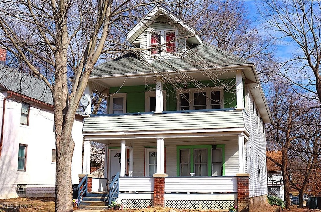 view of front of home with a balcony, covered porch, and a shingled roof