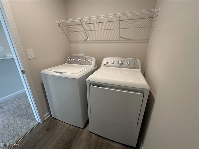 laundry area with laundry area, baseboards, dark wood-style floors, and washer and dryer