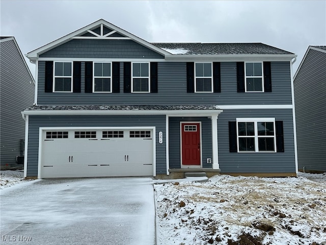 view of front of home with concrete driveway and an attached garage