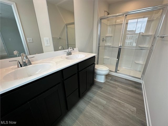 full bathroom with a sink, toilet, and a shower stall