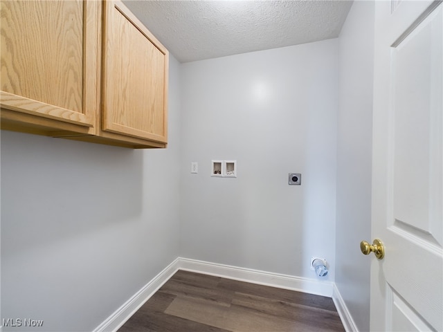 laundry room with dark wood-style floors, hookup for a washing machine, hookup for an electric dryer, a textured ceiling, and baseboards