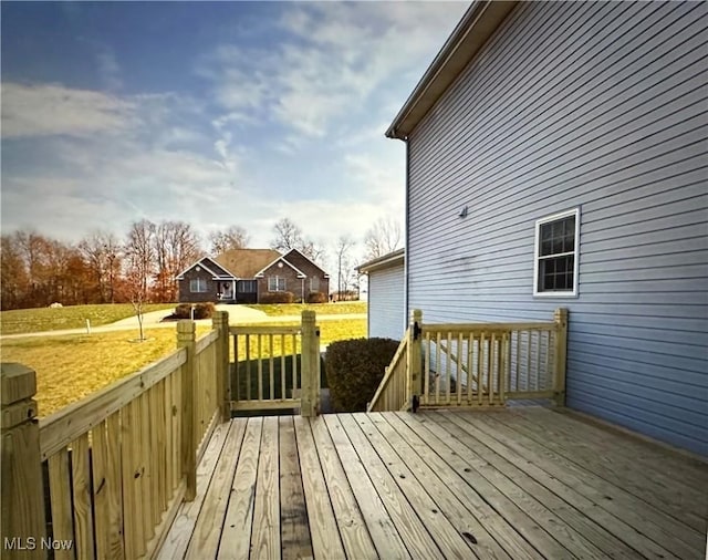 wooden deck with a lawn