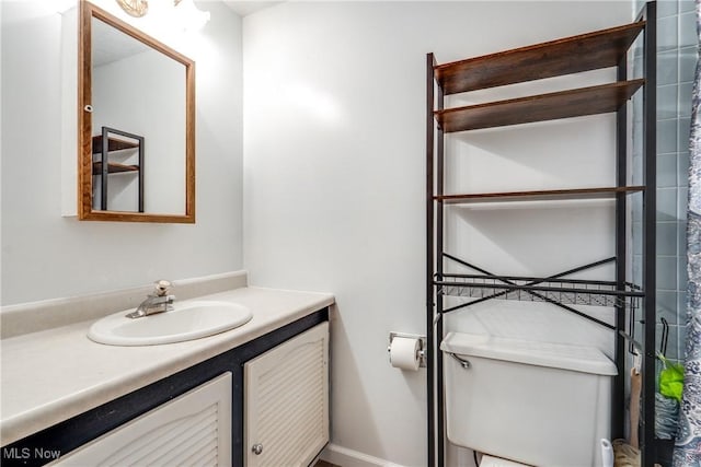 bathroom featuring toilet and vanity