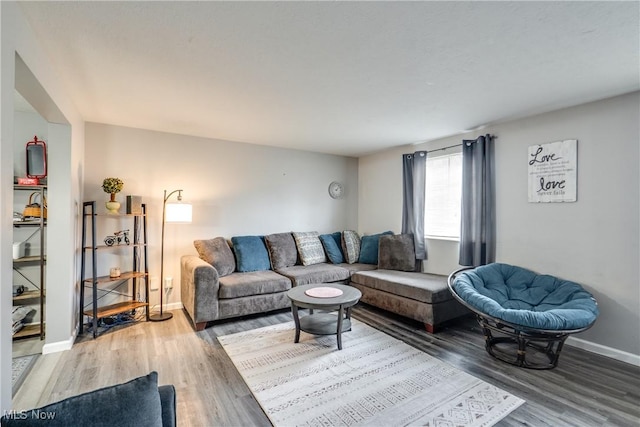 living area with light wood-style floors and baseboards