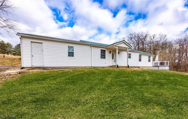 back of property featuring a yard