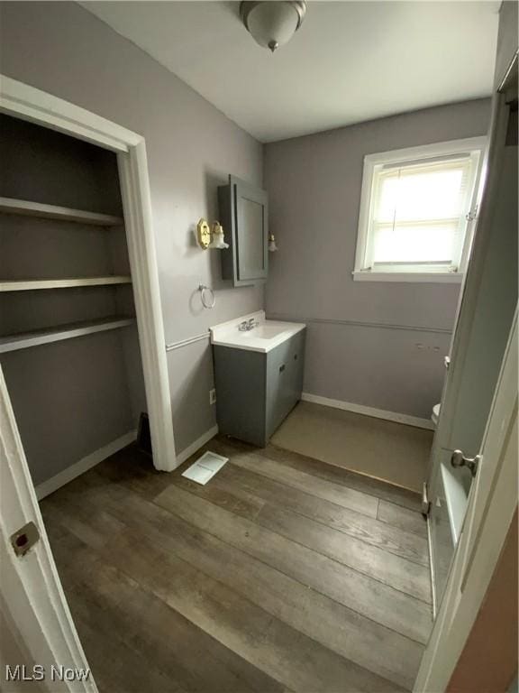 419 Vine St, East Liverpool, OH 43920 - bathroom with baseboards, wood finished floors, and vanity