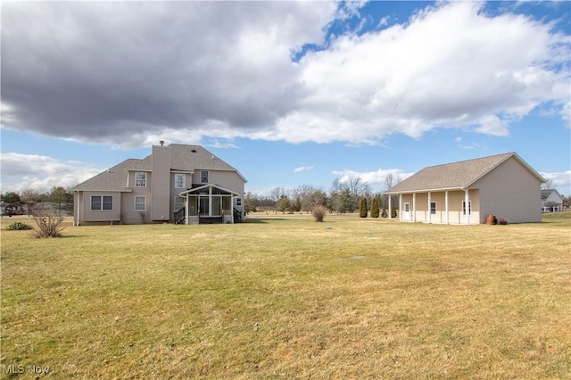 view of yard featuring a sunroom