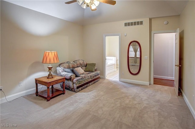 living area featuring a ceiling fan, carpet, visible vents, and baseboards