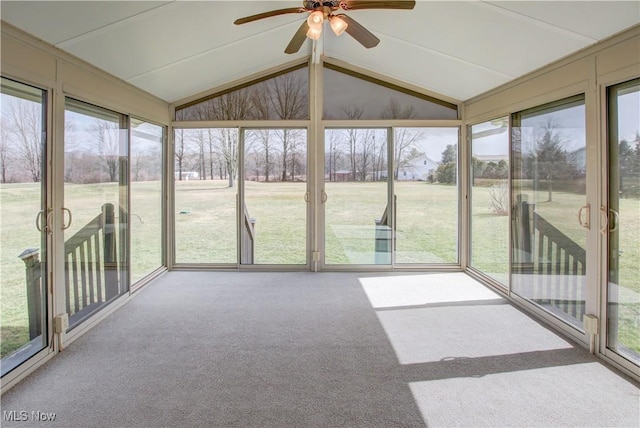 unfurnished sunroom with vaulted ceiling and ceiling fan