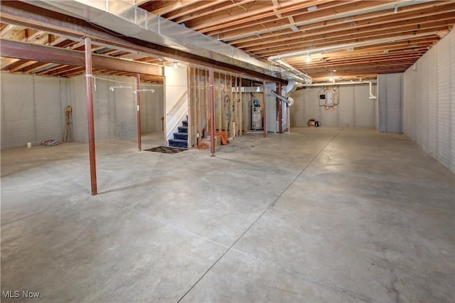 unfinished basement featuring gas water heater and heating unit