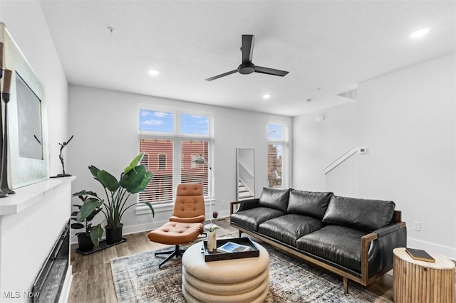 living room with recessed lighting, ceiling fan, baseboards, and wood finished floors