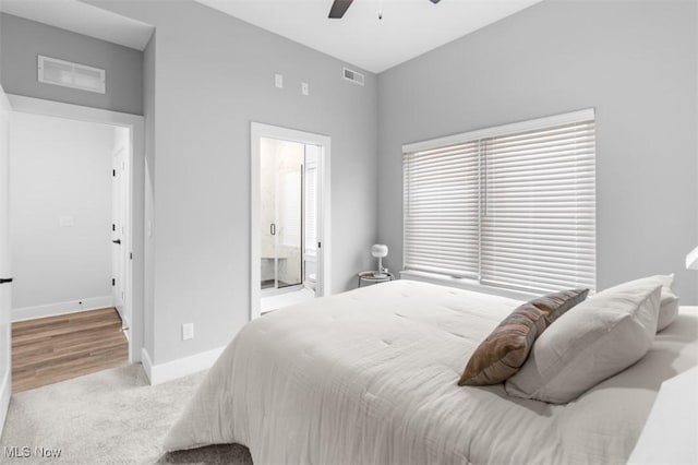 carpeted bedroom featuring baseboards, connected bathroom, visible vents, and a ceiling fan