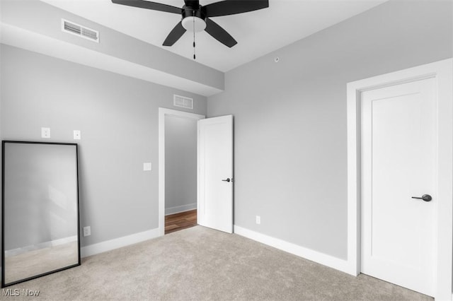 unfurnished bedroom with baseboards, visible vents, and carpet flooring