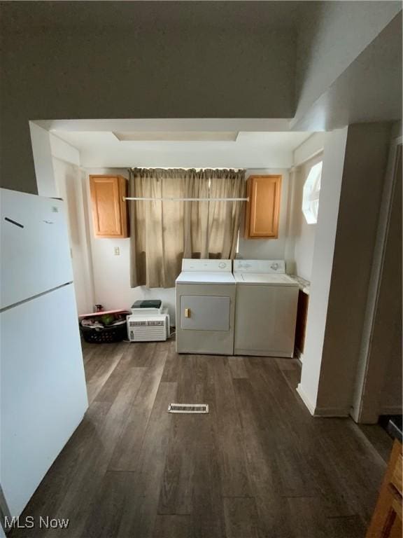 406 Vine St, East Liverpool, OH 43920 - kitchen with visible vents, dark wood-type flooring, freestanding refrigerator, and washer and dryer