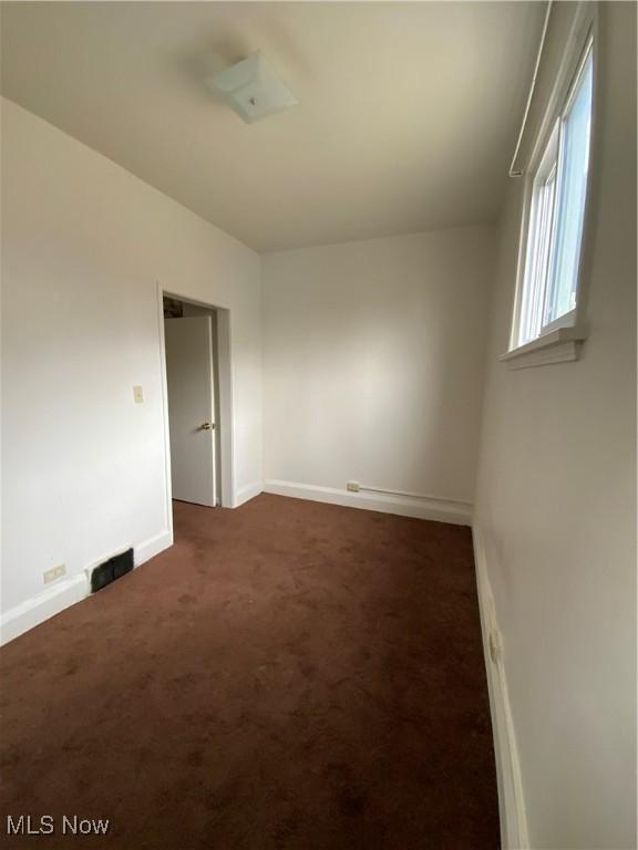 406 Vine St, East Liverpool, OH 43920 - empty room with dark colored carpet, visible vents, and baseboards