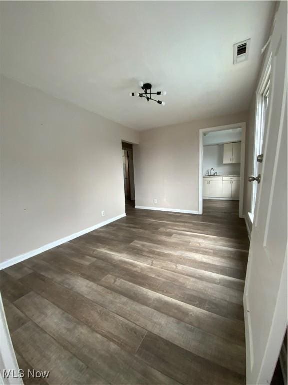 406 Vine St, East Liverpool, OH 43920 - spare room featuring dark wood-style flooring, visible vents, and baseboards
