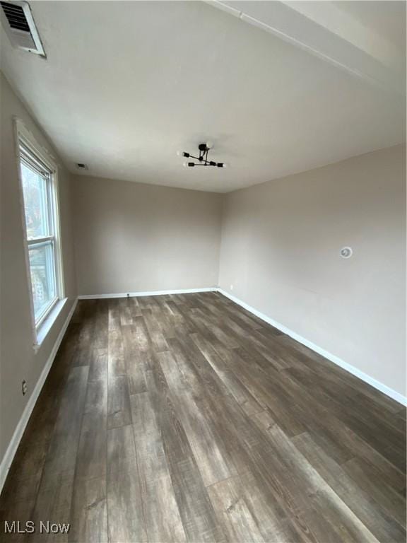 406 Vine St, East Liverpool, OH 43920 - spare room featuring dark wood-style flooring, visible vents, and baseboards
