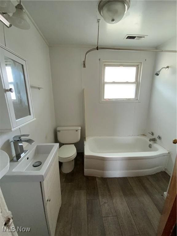 406 Vine St, East Liverpool, OH 43920 - bathroom featuring toilet, ornamental molding, wood finished floors, vanity, and shower / washtub combination