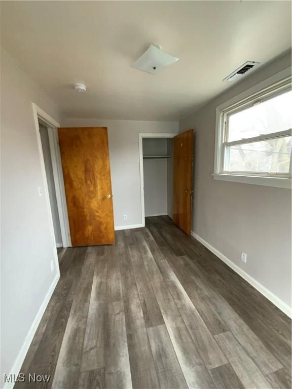 406 Vine St, East Liverpool, OH 43920 - unfurnished bedroom featuring dark wood-type flooring, a closet, visible vents, and baseboards