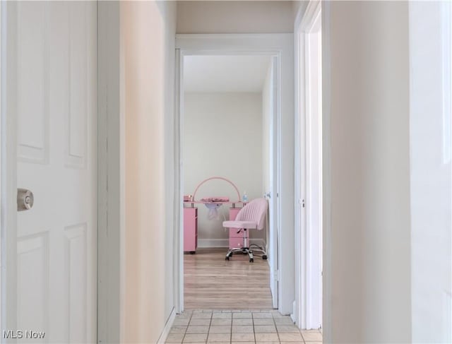 corridor featuring light tile patterned floors