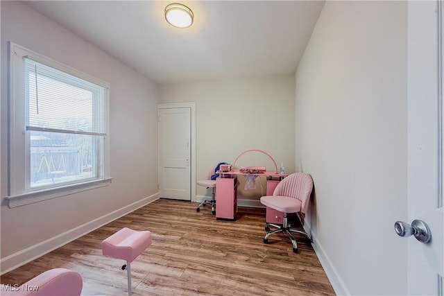 recreation room featuring baseboards and wood finished floors