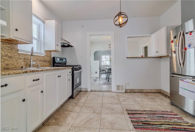 kitchen with appliances with stainless steel finishes, white cabinets, visible vents, and a sink