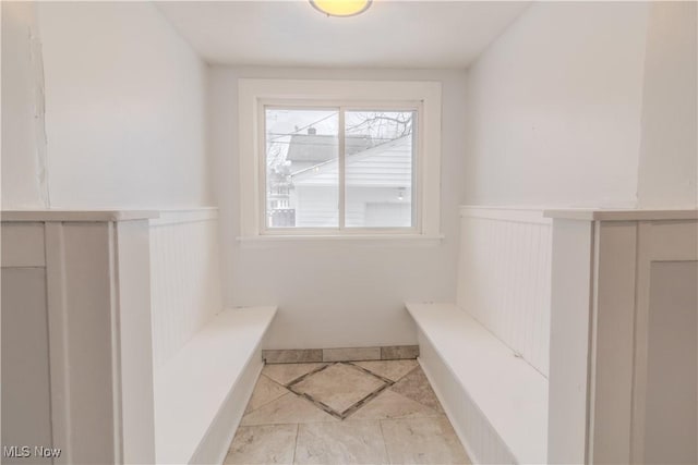 interior space featuring a wainscoted wall