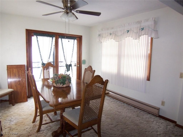 dining space featuring ceiling fan, plenty of natural light, baseboard heating, and light colored carpet