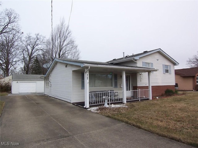 split level home featuring an outbuilding, brick siding, a porch, concrete driveway, and a front lawn