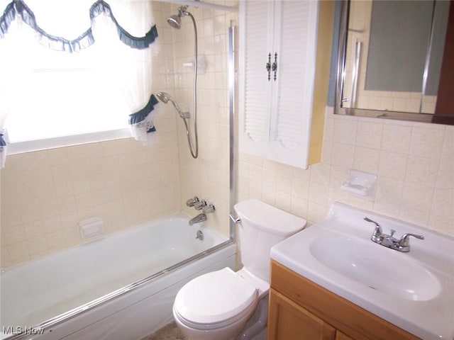 full bathroom with washtub / shower combination, tile walls, toilet, and vanity