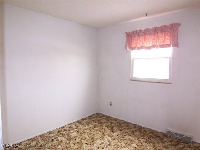 spare room with carpet flooring and visible vents