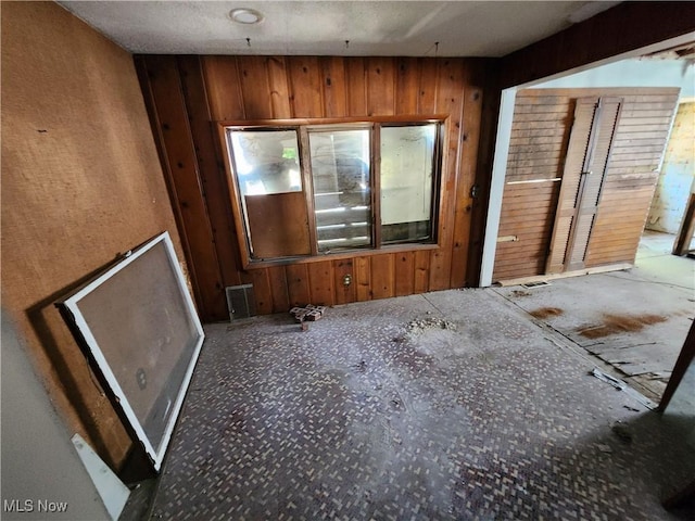 interior space with visible vents and wooden walls