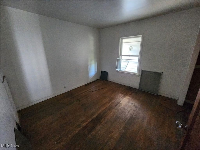 spare room with wood finished floors