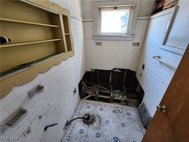 bathroom with tile walls and tile patterned floors