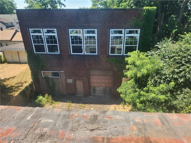 view of front of house featuring a garage and brick siding