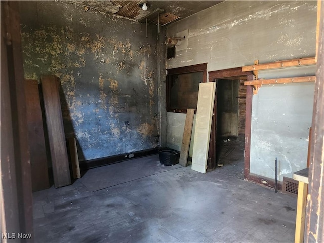 unfurnished room with concrete floors