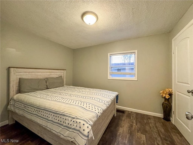 5192 University Dr, Geneva, OH 44041 - bedroom with a textured ceiling, wood finished floors, visible vents, and baseboards