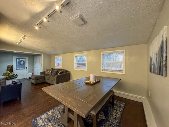 5192 University Dr, Geneva, OH 44041 - dining space with a textured ceiling, lofted ceiling, wood finished floors, visible vents, and baseboards