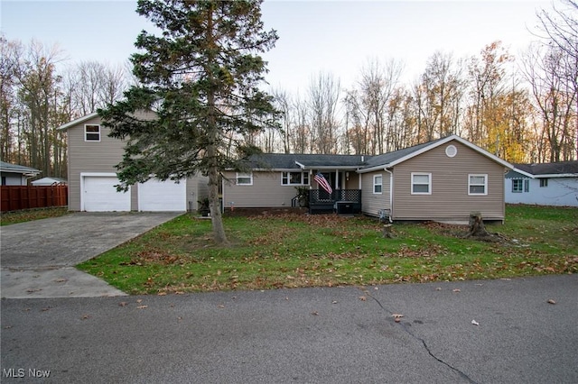 view of front of home with a front yard, fence, and driveway