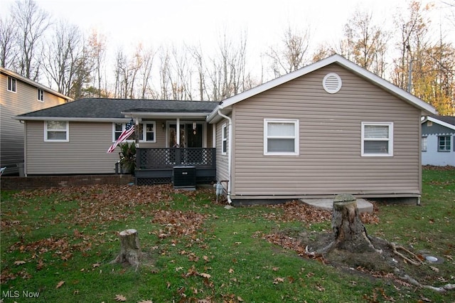 5192 University Dr, Geneva, OH 44041 - rear view of property with central air condition unit, a porch, and a yard