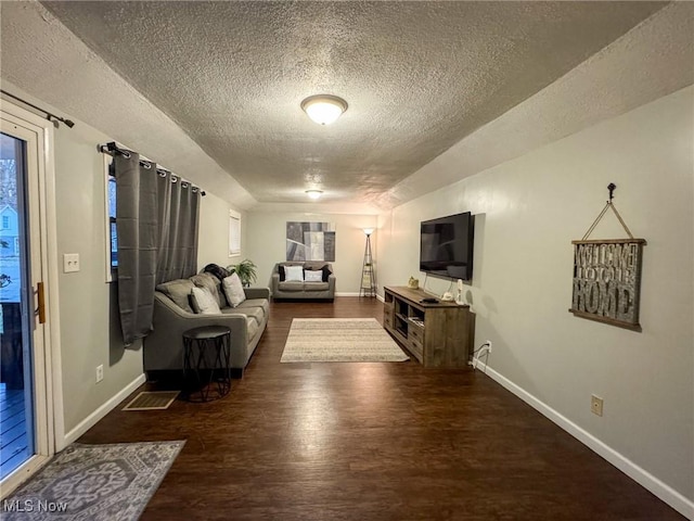 5192 University Dr, Geneva, OH 44041 - living area with a textured ceiling, wood finished floors, and baseboards